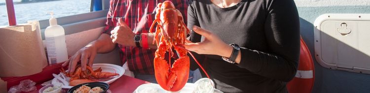 A couple shows off their Lobster Dinner